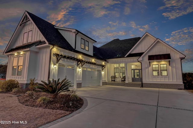 modern farmhouse featuring board and batten siding, a shingled roof, a standing seam roof, and concrete driveway