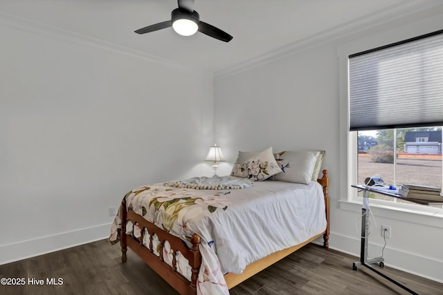 bedroom featuring ceiling fan, baseboards, crown molding, and wood finished floors