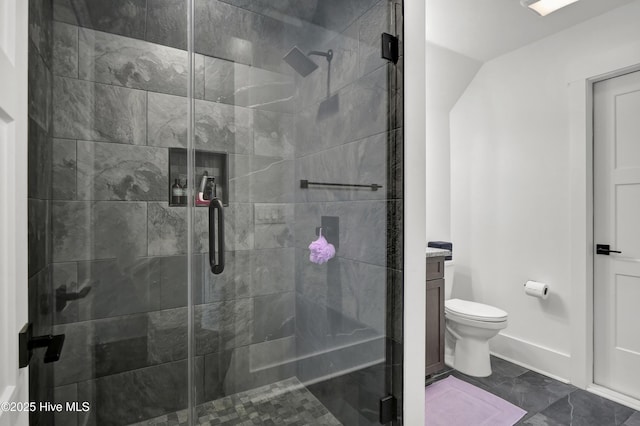 bathroom featuring a stall shower, vanity, and toilet