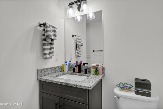 half bathroom featuring toilet and vanity