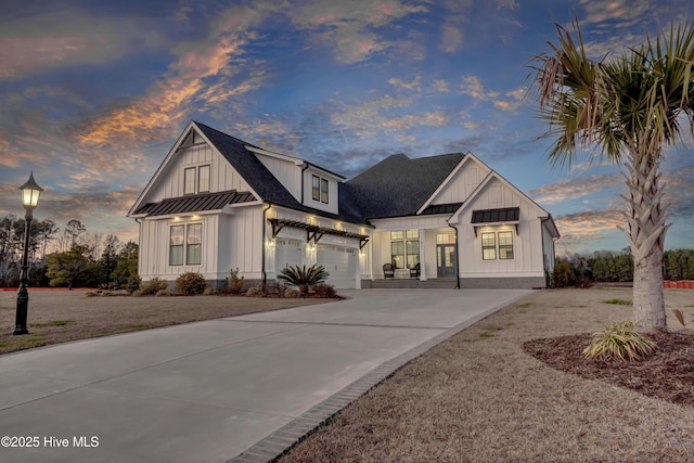 modern inspired farmhouse with driveway, board and batten siding, a garage, a standing seam roof, and metal roof