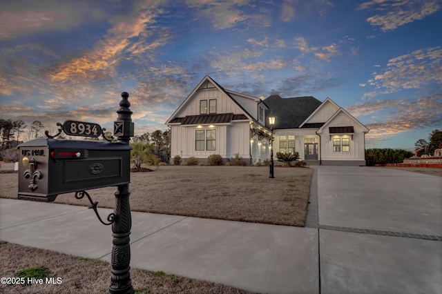 view of front of house with a standing seam roof, metal roof, and board and batten siding