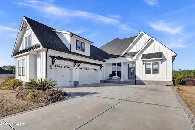 modern farmhouse style home featuring driveway, a shingled roof, a garage, board and batten siding, and a standing seam roof