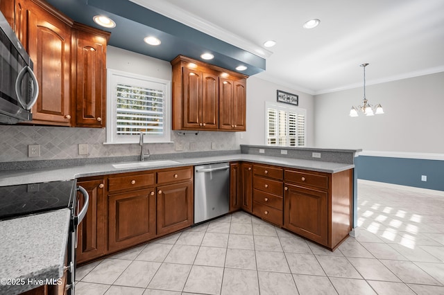 kitchen with brown cabinets, appliances with stainless steel finishes, light countertops, and a sink