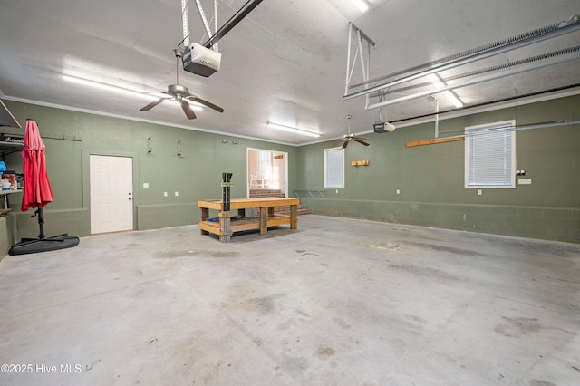 garage featuring concrete block wall and a garage door opener