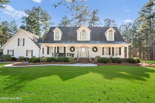 new england style home with a porch and a front yard