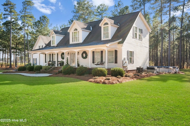 new england style home with covered porch and a front lawn