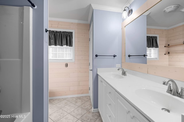 bathroom with crown molding, wooden walls, visible vents, and a sink