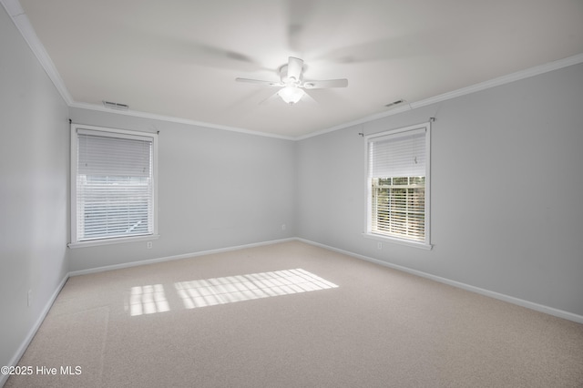 unfurnished room with ceiling fan, ornamental molding, visible vents, and baseboards