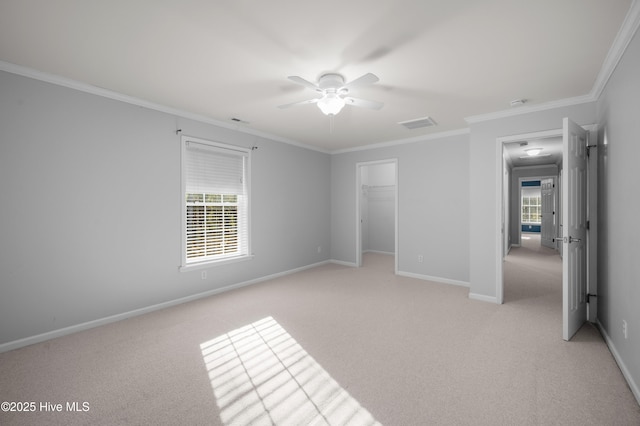 empty room with light carpet, plenty of natural light, and baseboards