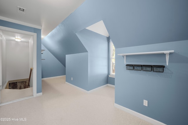 bonus room with baseboards, vaulted ceiling, and carpet flooring