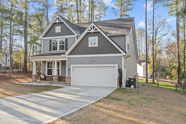 craftsman-style house with an attached garage, covered porch, brick siding, fence, and driveway