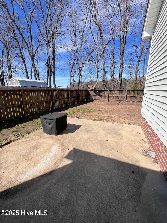 view of yard featuring a patio area and a fenced backyard