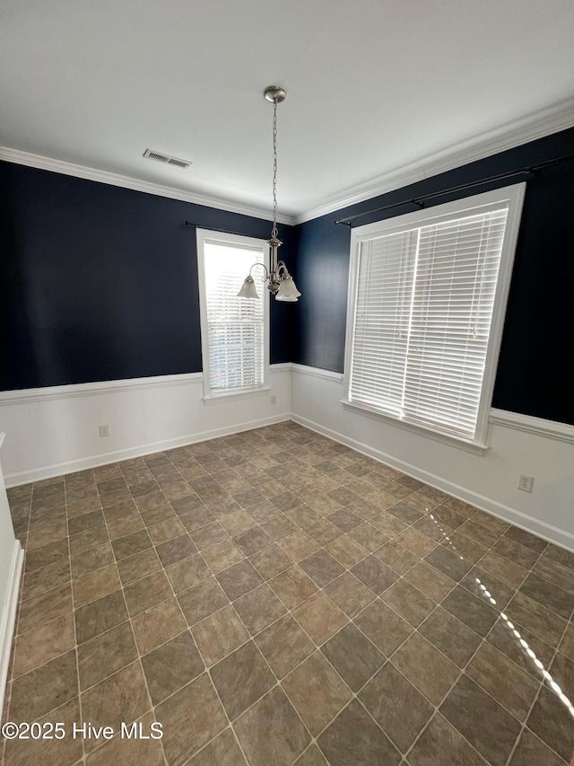 unfurnished dining area featuring a chandelier, ornamental molding, visible vents, and baseboards