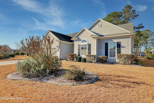 view of front of house with a garage and a front lawn