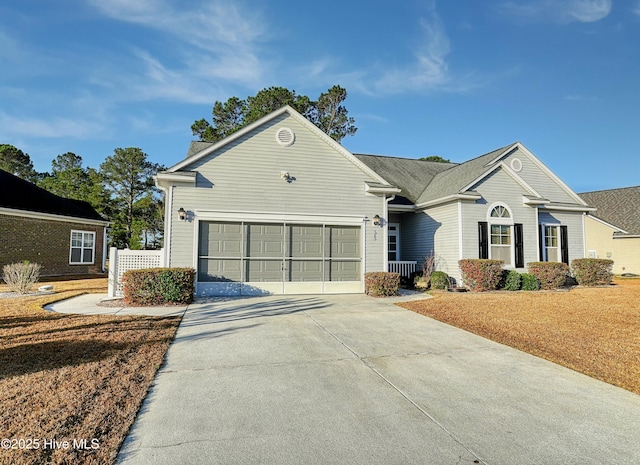 ranch-style house featuring a garage and concrete driveway