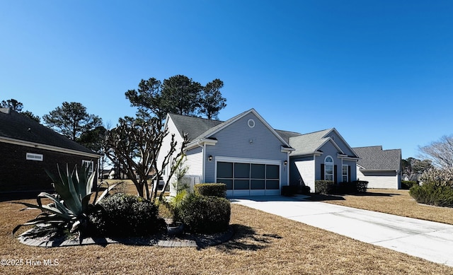 view of side of home featuring an attached garage and concrete driveway