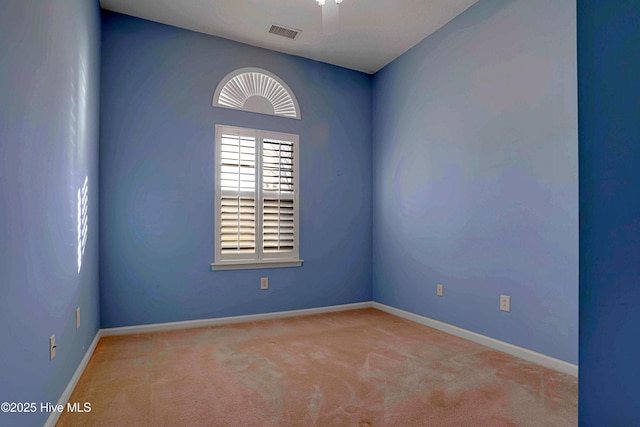 unfurnished room featuring baseboards, visible vents, and carpet flooring