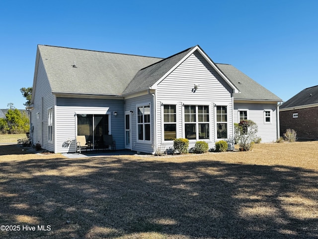 back of property featuring a patio and roof with shingles