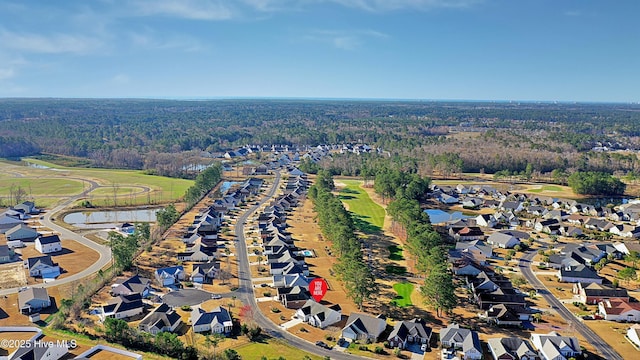 birds eye view of property with a residential view and a wooded view