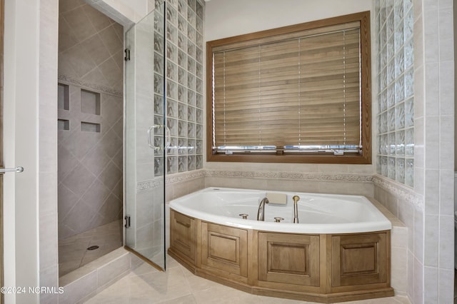 23 Comber Rd, Wilmington, NC 28411 - bathroom with a garden tub, a shower stall, tile patterned flooring, and tile walls