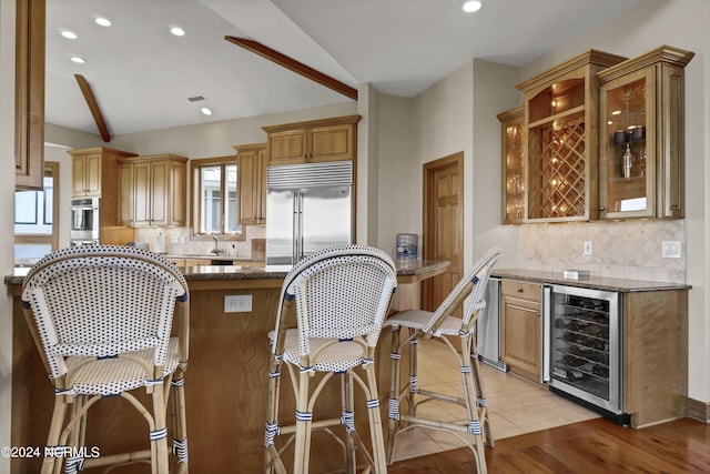 23 Comber Rd, Wilmington, NC 28411 - kitchen with beverage cooler, stainless steel appliances, vaulted ceiling, and dark stone counters