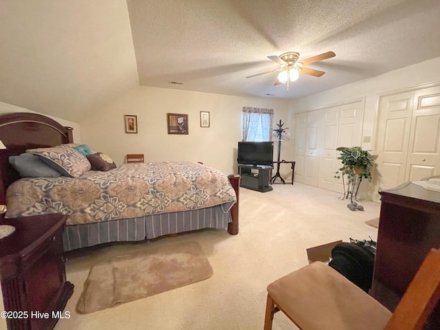 bedroom with a textured ceiling, carpet floors, ceiling fan, and lofted ceiling