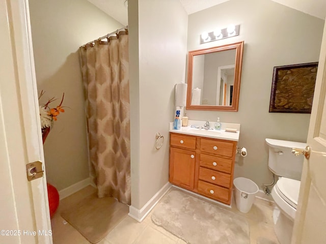 bathroom with tile patterned flooring, a shower with curtain, vanity, and toilet