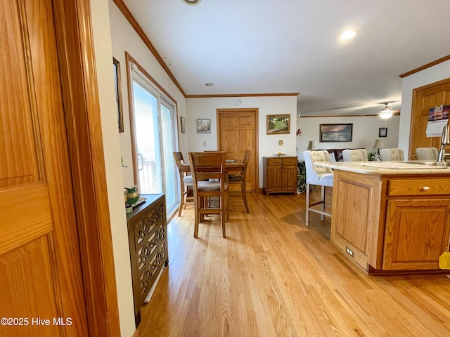 interior space featuring light wood-style floors and crown molding