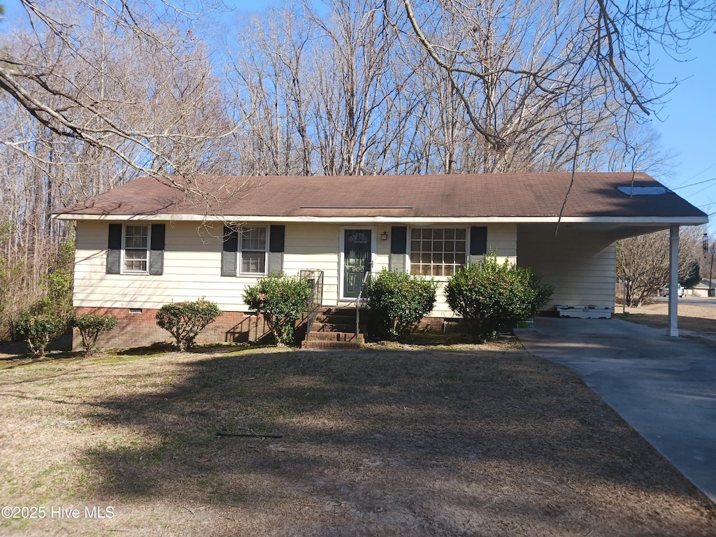 ranch-style home featuring crawl space, driveway, and a carport