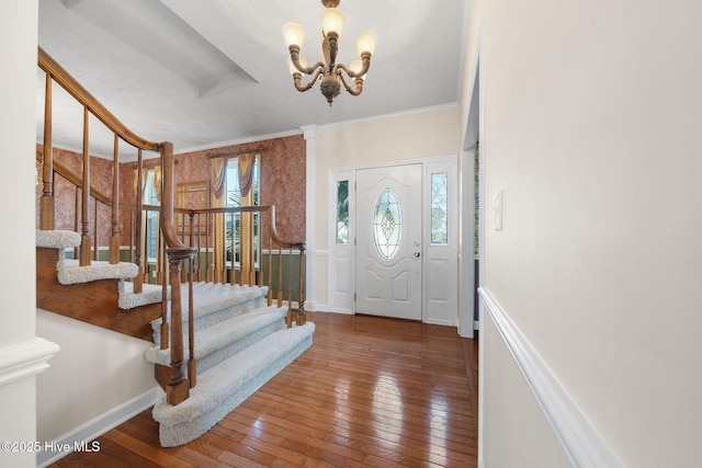 entryway with baseboards, crown molding, stairway, and hardwood / wood-style floors