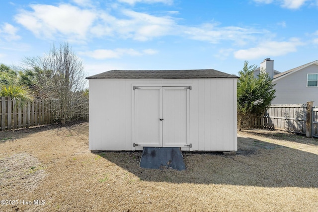 view of shed with a fenced backyard