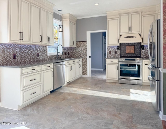 kitchen with stainless steel appliances, a sink, hanging light fixtures, custom exhaust hood, and crown molding