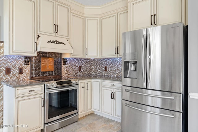 kitchen featuring tasteful backsplash, cream cabinets, custom exhaust hood, and stainless steel appliances