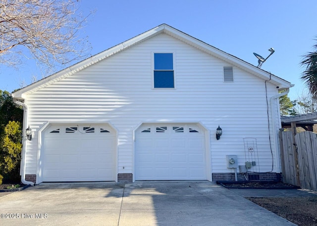 view of property exterior with a garage and fence