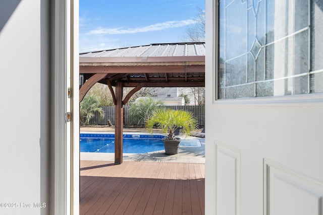 view of pool with fence, a deck, a fenced in pool, and a gazebo