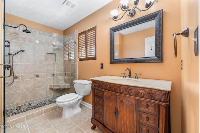 full bath with tile patterned flooring, toilet, vanity, visible vents, and a tile shower