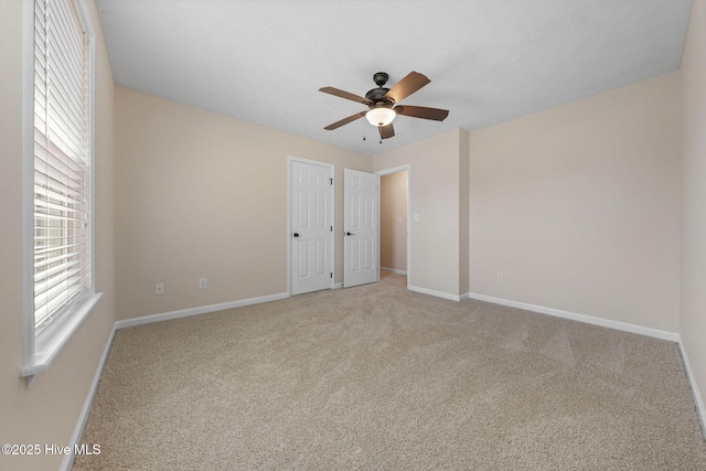 empty room with baseboards and carpet flooring