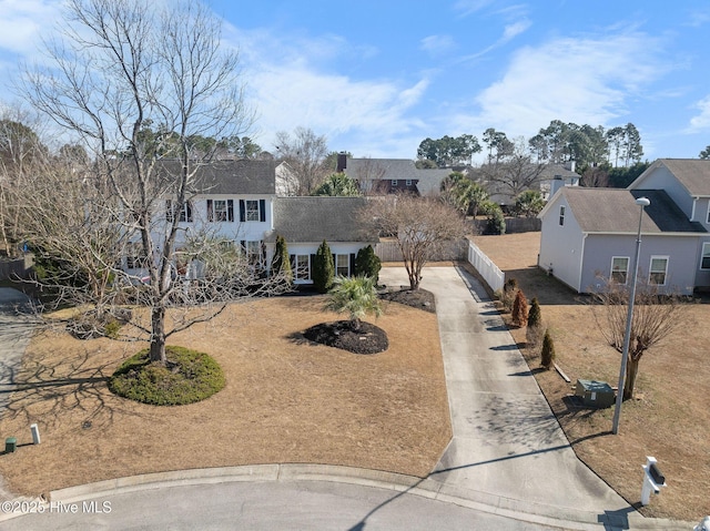 view of front of home featuring fence and driveway