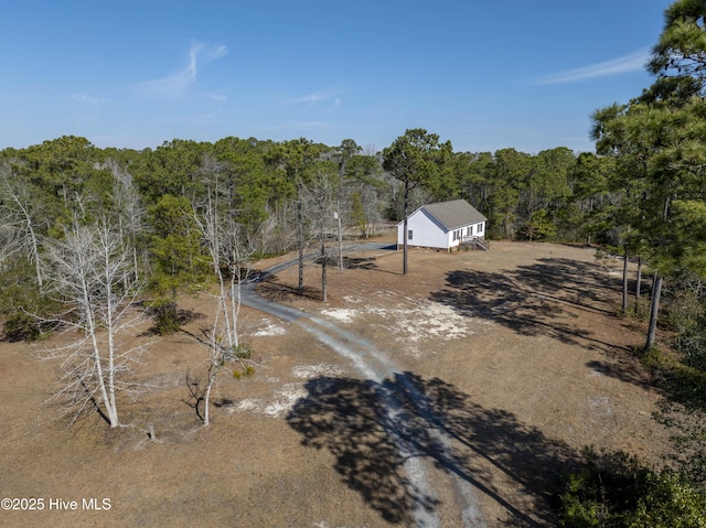 birds eye view of property with a forest view