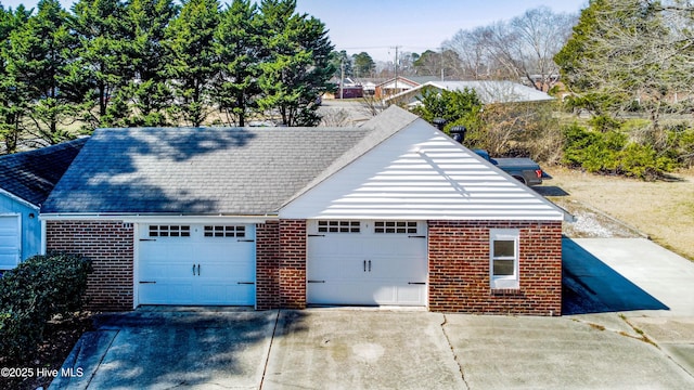 exterior space with brick siding and a detached garage