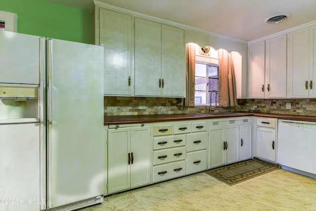 kitchen featuring white appliances, a sink, visible vents, tasteful backsplash, and dark countertops