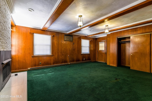 interior space with beam ceiling, a fireplace, dark colored carpet, baseboard heating, and wood walls