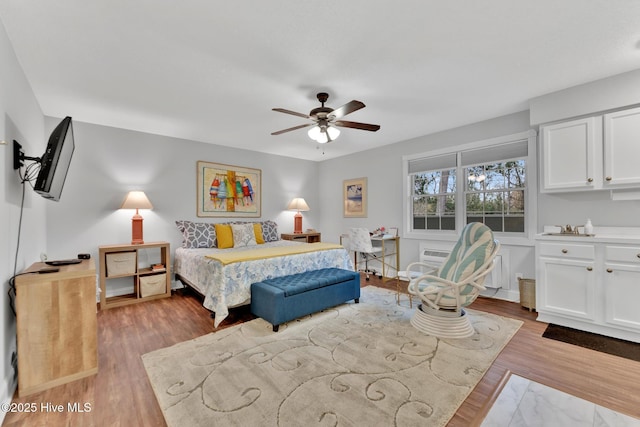 bedroom featuring a ceiling fan and wood finished floors