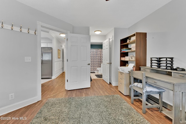office space featuring light wood-type flooring and baseboards