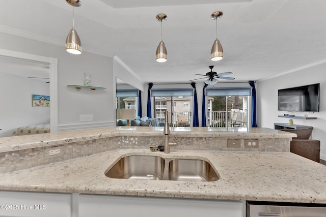 908 Resort Cir Unit 408, Sunset Beach, NC 28468 - kitchen featuring open floor plan, a sink, ornamental molding, and decorative light fixtures