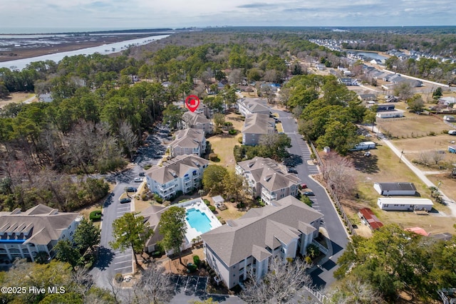 birds eye view of property featuring a view of trees