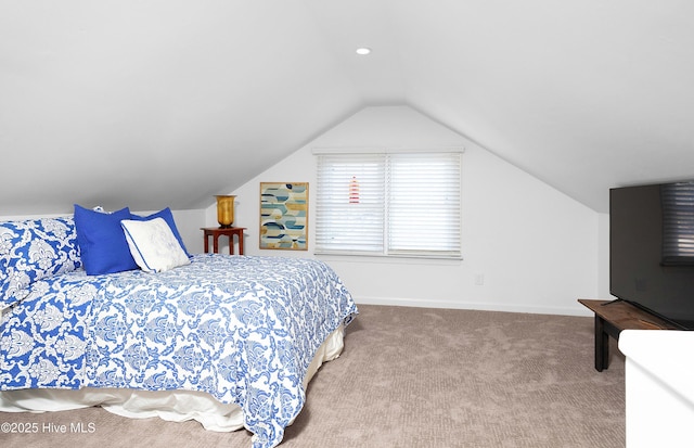 carpeted bedroom with lofted ceiling and baseboards