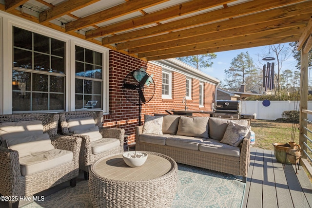 view of patio featuring fence, an outdoor living space, and area for grilling