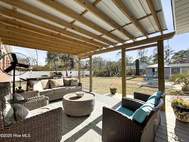 view of patio with an outdoor kitchen, outdoor lounge area, and fence